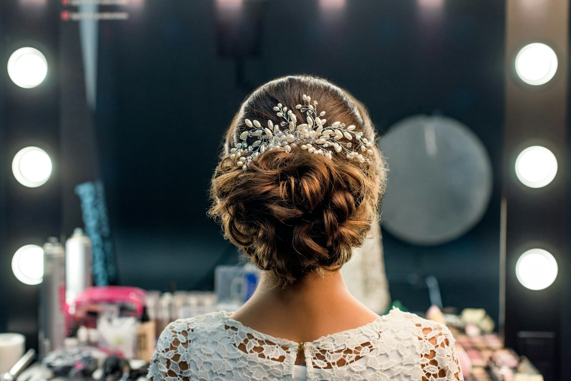 back view of woman with elegant hairstyle and accessory in beauty studio